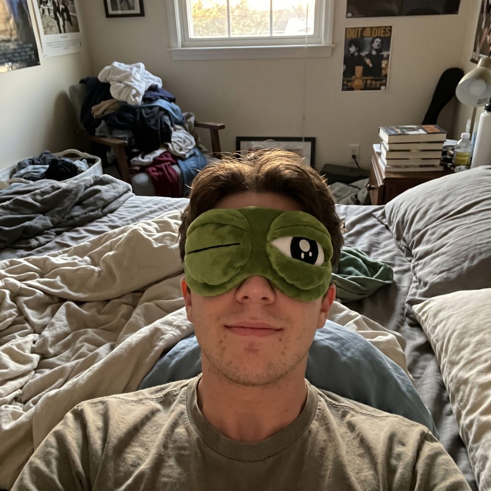 Person reclining in a Snugsy Frog Mask